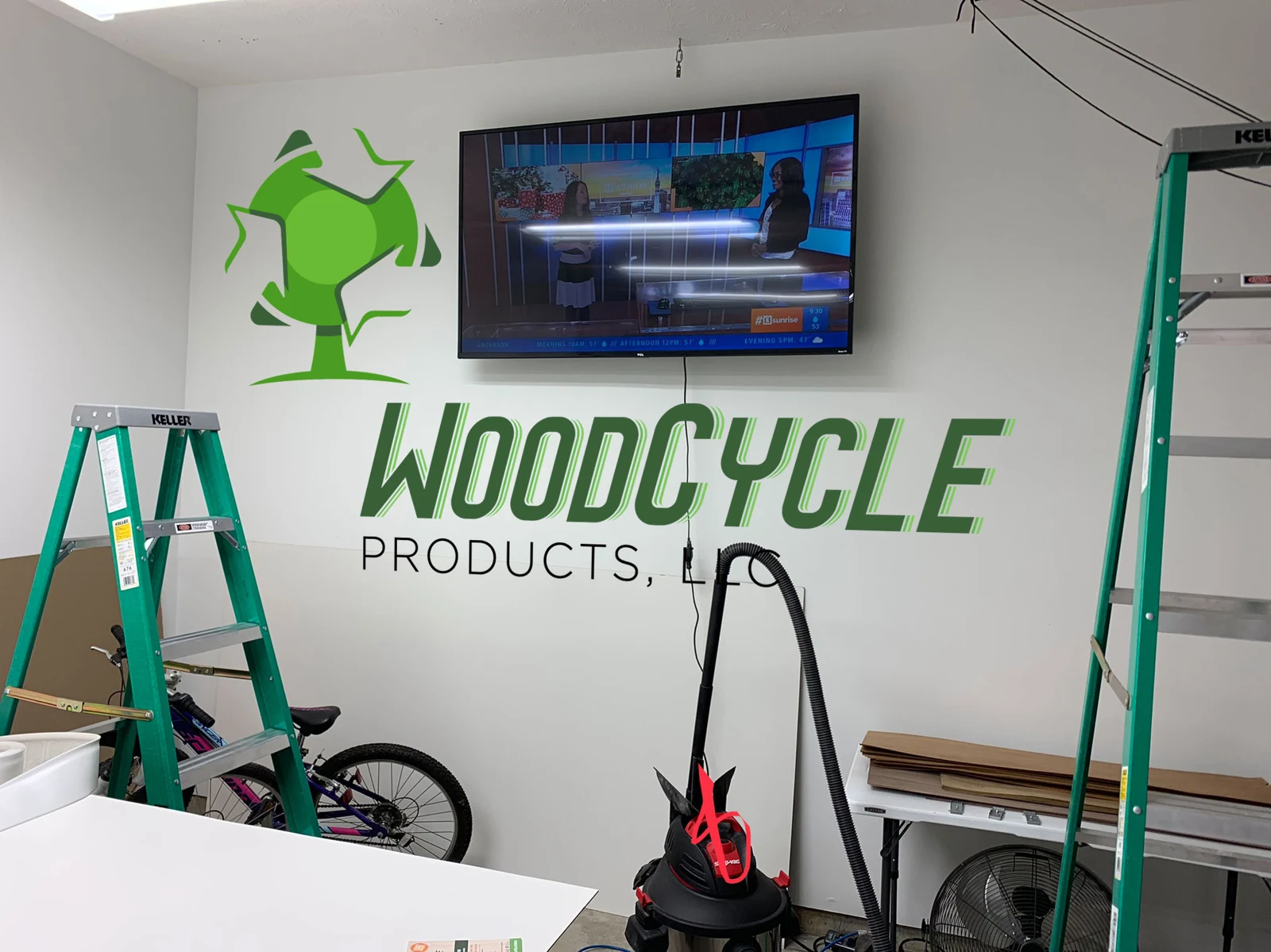 WoodCycle logo painted on shop wall — branding photograph